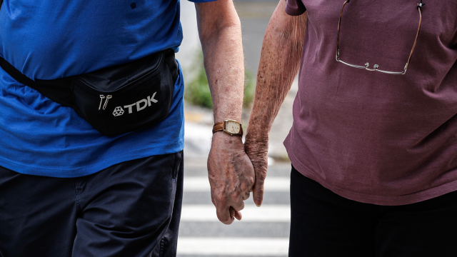 An elderly couple walks in a street in Sao Paulo, Brazil, 27 October 2023.