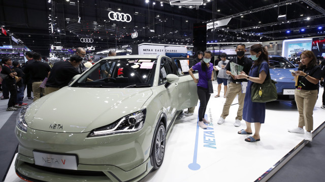 Visitors inspect a Chinese made NETA V electric car displayed at the 40th Thailand International Motor Expo 2023 in Bangkok, Thailand, 04 December 2023